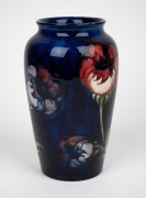 MOORCROFT "Poppy" pattern pottery vase on blue ground, impressed factory mark and remains of original paper label, 20.5cm high. - 2