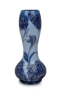 MOORCROFT "Lilac" pattern pottery vase on sky blue ground, stamped "Florian Ware, JAS. MACINTYRE" and signed "W. Moorcroft", ​​​​​​​28cm high.