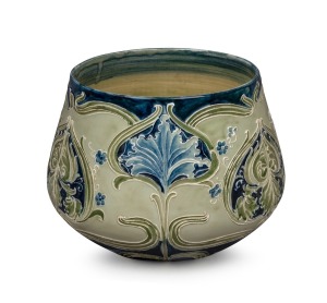 MOORCROFT "Florian Ware" pottery jardiniere on celadon green ground with blue highlights with iris and forget me not decoration, signed in green "W. Moorcroft, des.", 19cm high, 26cm diameter.