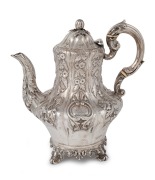 An antique English sterling silver coffee pot with floral repousse decoration and fruit finial, made in London, circa 1842, 24cm high, 1030 grams.