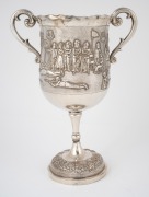 An Indian silver trophy cup with repousse shooting scene, with Calcutta retailer's stamp, 19th century, 25.5cm high, 582 grams. - 2