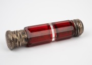 An antique faceted ruby glass double-ended scent bottle with silver tops, 19th century, ​​​​​​​10cm long. - 2