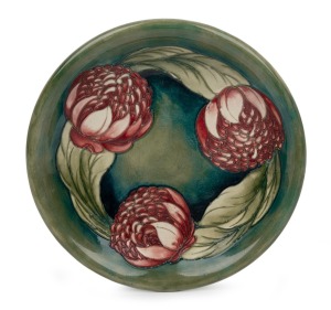MOORCROFT "Waratah" pottery bowl on celadon green ground, impressed signature mark to base "Moorcroft, Potter To H.M. The Queen,. Made In England", 22.5cm diameter.