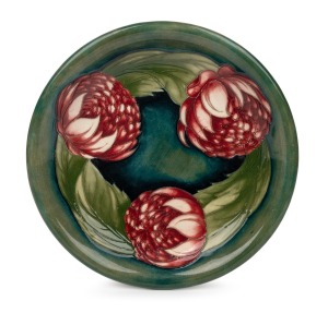 MOORCROFT "Waratah" pottery bowl on celadon green ground trending to dark blue on the reverse, impressed signature mark to base "Moorcroft, Potter To H.M. The Queen,. Made In England", 22.5cm diameter.