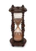 An antique English turned rosewood hourglass carved with English rose, 19th century, 20.5cm high.