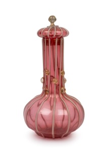 An unusual Murano ruby glass decanter with gold foil inclusions, applied prunts and trailing decoration in the Arabesque style, circa 1920s, 28cm high.