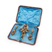 A stunning antique high carat yellow gold cross pendant and matching earrings adorned with two-tone gold florets, set in carbuncle garnets, housed in original leather case with blue silk interior, circa 1860, ​​​​​​​the cross an impressive 9cm high, 19 gr - 4