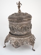 An antique Burmese silver cylindrical lidded box on stand with repousse decoration and finely cast figural finial, early 20th century, 31cm high, 1425 grams. - 2