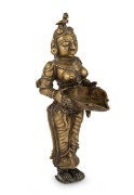 An antique Burmese cast bronze statue of a woman, 19th/20th century, ​​​​​​​23.5cm high.