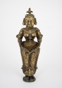 An antique Burmese cast bronze statue of a woman, 19th/20th century, ​​​​​​​23.5cm high. - 2