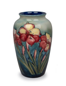 MOORCROFT "Fresia" pattern pottery vase on green and blue ground, impressed signature mark "Moorcroft, Made In England, Potter To H.M. The Queen", ​​​​​​​32cm high.