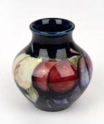 MOORCROFT "Wisteria" pottery vase on blue ground, impressed "Moorcroft, Made In England", 8cm high.