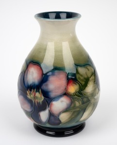 MOORCROFT "Clematis" pattern baluster shaped vase on cream and celadon ground with blue blush, impressed signature mark "W. Moorcroft, Potter To H.M. The Queen, Made In England", 16cm high.