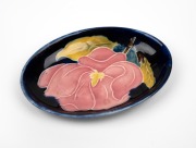 MOORCROFT floral pin dish on blue ground, impressed "MOORCROFT", ​​​​​​​11.5cm wide.