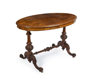 A good quality antique Irish walnut oval occasional table with marquetry and carved decoration, circa 1870, 73cm high, 104cm wide, 67cm deep.