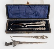 Three antique silver handled button hooks, sterling silver fork and an Eastern silver letter opener in the form of a Kris, 19th/20th century, (6 items), the largest 18cm long.