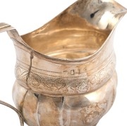 An antique sterling silver milk jug with bright cut decoration, most likely Channel Islands (marks rubbed), early 19th century, 11cm high, 16cm wide, 150 grams. - 3