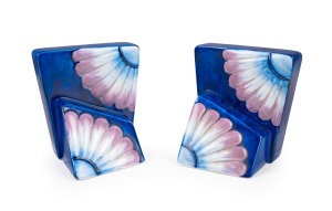 CARLTON WARE pair of English porcelain Art Deco bookends with floral decoration on blue ground, black factory mark to base, 13cm high.