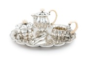 JOSEF HOFFMANN (1870-1956), WIENER WERKST&Auml;TTE stunning Austrian silver and ivory tea service, comprising a teapot, milk jug, sugar bowl, sugar tongs and tray, circa 1918. This model tea service was exhibited at the, Arts Decoratifs Et Industriels Modernes