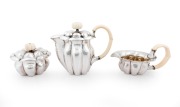 JOSEF HOFFMANN (1870-1956), WIENER WERKST&Auml;TTE stunning Austrian silver and ivory tea service, comprising a teapot, milk jug, sugar bowl, sugar tongs and tray, circa 1918. This model tea service was exhibited at the, Arts Decoratifs Et Industriels Modernes - 2