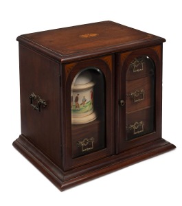An antique English Sheraton Revival mahogany smoker's cabinet with glass doors, fitted drawers and porcelain tobacco jar with golfing motif, late 19th century, 35cm high, 35cm wide, 27cm deep.