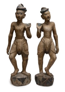 A pair of antique Burmese carved wooden figures with polychrome finish, 19th/20th century, 76cm and 73cm high.