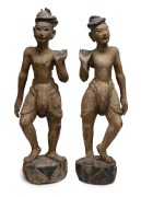 A pair of antique Burmese carved wooden figures with polychrome finish, 19th/20th century, 76cm and 73cm high.