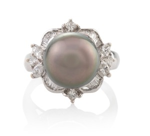 An 18ct white gold and platinum ring, set with an impressive black South Seas pearl surrounded by baguette, marquise and brilliant cut white diamonds, stamped "750",