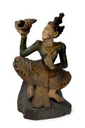 An antique Burmese carved wood and polychrome finished statue of a lady holding a conch shell, 19th/20th century, 49cm high.