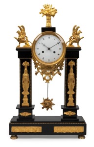 435 · An antique French Empire pillar clock in black slate case with gilt metal mounts and decoration, eight day time and bell striking movement with silk suspension, circa 1820s, 56cm high.