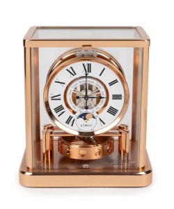 452 · JAEGER LECOULTRE "Classique Phases De Lune" Atmos clock in rose gold plated case, with month and phases of the moon, circa early 2000s, 23cm high.