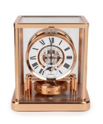 JAEGER LECOULTRE "Classique Phases De Lune" Atmos clock in rose gold plated case, with month and phases of the moon, circa early 2000s, 23cm high.