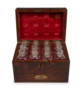 An antique English mahogany apothecary box with red velvet fitted interior housing twelve original glass bottles, early to mid 19th century, ​​​​​​​13cm high, 19.5cm wide, 13cm deep.