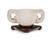 An antique Chinese carved mutton jade cup on later carved timber stand, Ming Dynasty, 6cm high, 13.5cm wide, 8cm high on stand. PROVENANCE: The Rod Thomas Collection, Melbourne. - 2