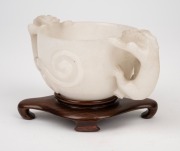 An antique Chinese carved mutton jade cup on later carved timber stand, Ming Dynasty, 6cm high, 13.5cm wide, 8cm high on stand. PROVENANCE: The Rod Thomas Collection, Melbourne. - 4