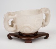 An antique Chinese carved mutton jade cup on later carved timber stand, Ming Dynasty, 6cm high, 13.5cm wide, 8cm high on stand. PROVENANCE: The Rod Thomas Collection, Melbourne. - 5