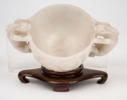 An antique Chinese carved mutton jade cup on later carved timber stand, Ming Dynasty, 6cm high, 13.5cm wide, 8cm high on stand. PROVENANCE: The Rod Thomas Collection, Melbourne. - 6