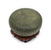 An antique Chinese carved jade box on carved timber stand, 19th/20th century, ​​​​​​​5.5cm high, 12cm wide, 9cm high including stand.