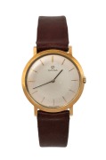 OMEGA vintage manual slimline gent's wristwatch in 18ct gold case with silvered dial and baton numerals, 3.2cm wide including crown.