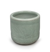 An antique Chinese celadon glazed brush pot, Qing Dynasty, 17th/18th century, 9.5cm high. ​​​​​​​PROVENANCE: The Rod Thomas Collection, Melbourne.