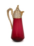 An antique ruby glass claret jug with ornate gilded silver top, 19th century, ​​​​​​​31cm high.