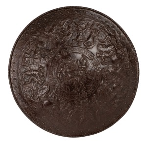An antique cast iron shield handsomely adorned with battle scenes, 19th century, ​​​​​​​55cm diameter.