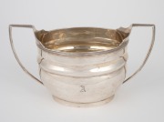 A Georgian sterling silver sugar basin made by Steven Adams I of London, circa 1806, ​​​​​​​10cm high, 18.5cm wide, 229 grams.