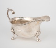 An antique English sterling silver sauce boat, made in London, 20th century, 8cm high, 15.5cm wide, 146 grams.