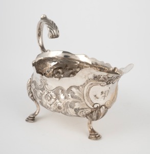 An antique silver jug with floral decoration and pad feet, 19th century, 10cm high, 14cm wide, 136 grams.