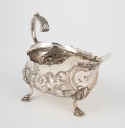 An antique silver jug with floral decoration and pad feet, 19th century, 10cm high, 14cm wide, 136 grams.