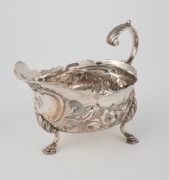 An antique silver jug with floral decoration and pad feet, 19th century, 10cm high, 14cm wide, 136 grams. - 2