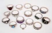 Sixteen assorted rings with stones including silver examples.
