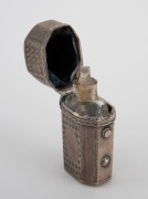 A Georgian sterling silver scent bottle holder with original crystal bottle, early 19th century, 5cm high. - 2