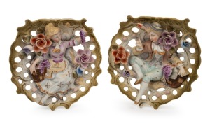 A pair of vintage figural bisque porcelain wall pockets with applied floral decoration, 20th century, ​​​​​​​18cm high.